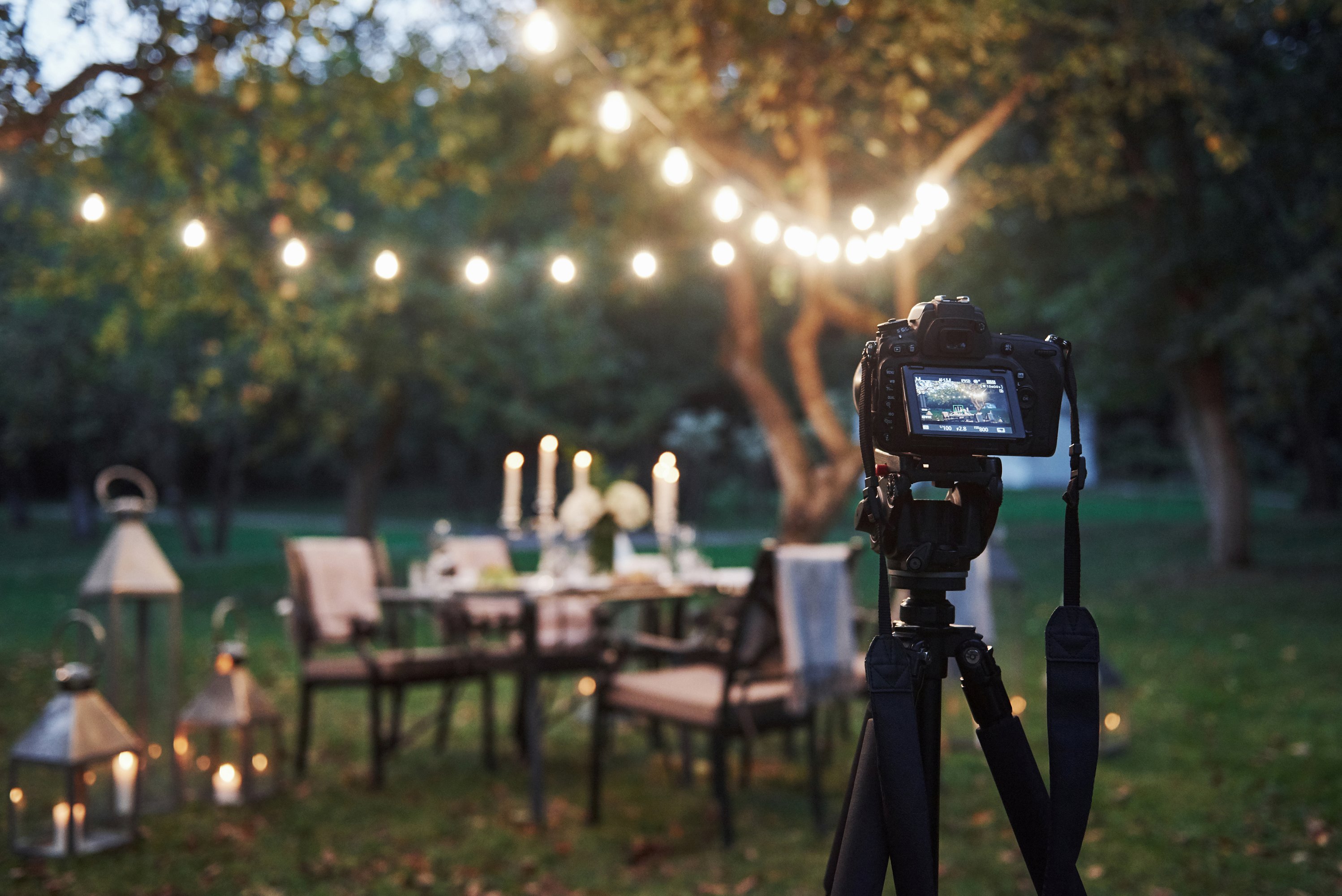 Indian photographer capturing a wedding couple under warm lights at night