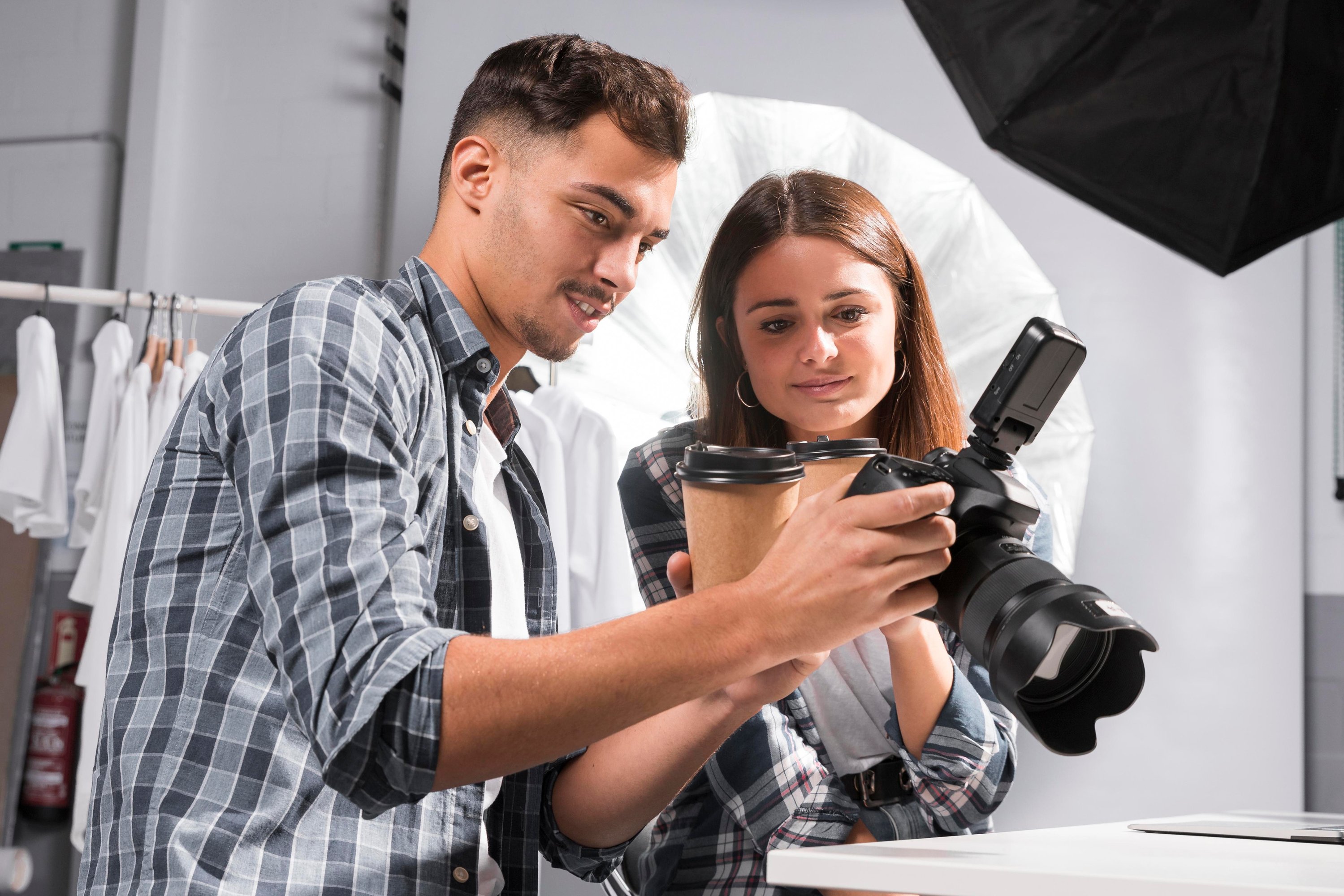 Woman and man reviewing photos on a camera during an online photography session